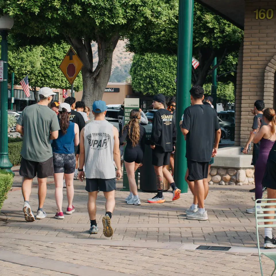 Runners walking across the brick plaza in Glendora before the run starts