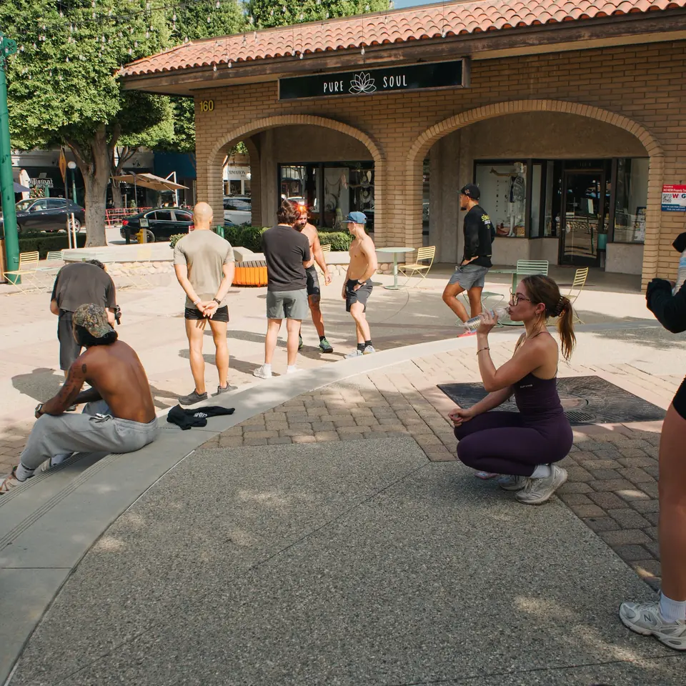 Runners cooling down and drinking water on the plaza outside Classic Coffee in Glendora