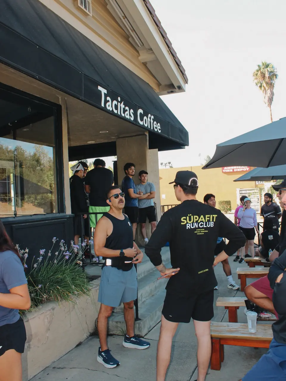 Runner in a SÜPAFIT Run Club long sleeve listening to a talk before the run