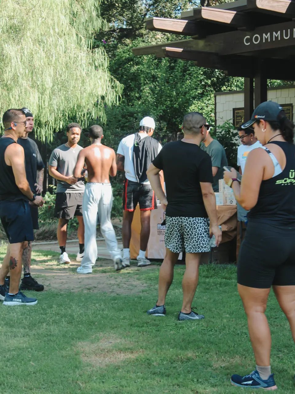 Runners chatting near the community building and snack table after the run