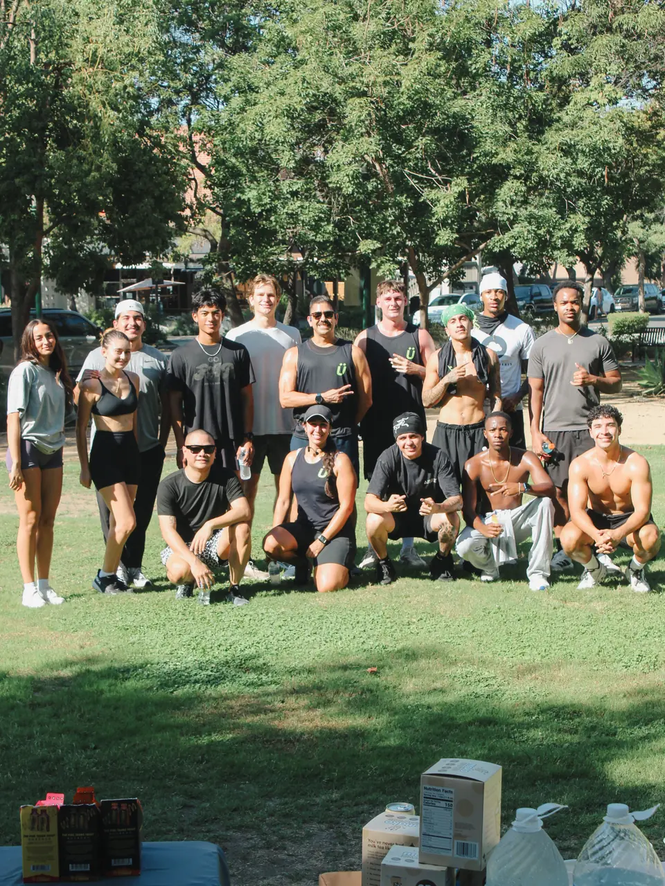 Group shot of the crew posing on the grass at Shelton Park in Claremont